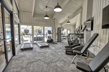 a spacious fitness center with treadmills and other exercise equipment